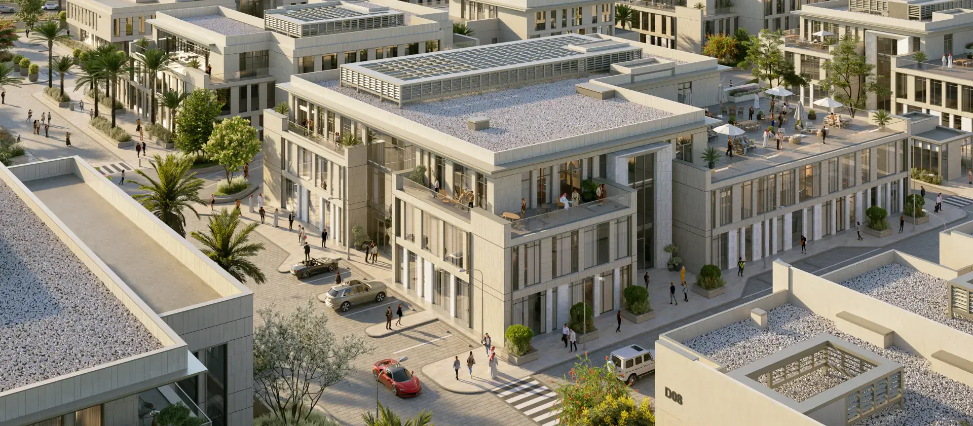Aerial view of a modern urban complex with minimalist buildings, rooftop terraces, and solar panels. Street lined with trees, cars, and people, conveying a lively urban atmosphere.