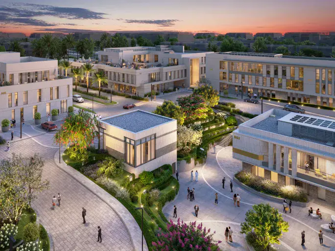 Prime at sunset with people walking along car-free paths next to lush greenery and low-rise office buildings